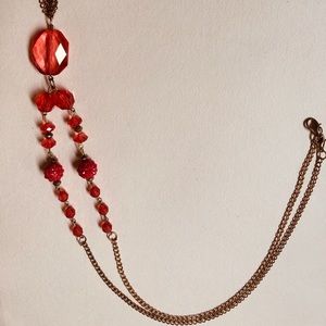 Gold colored necklace with pink beads
